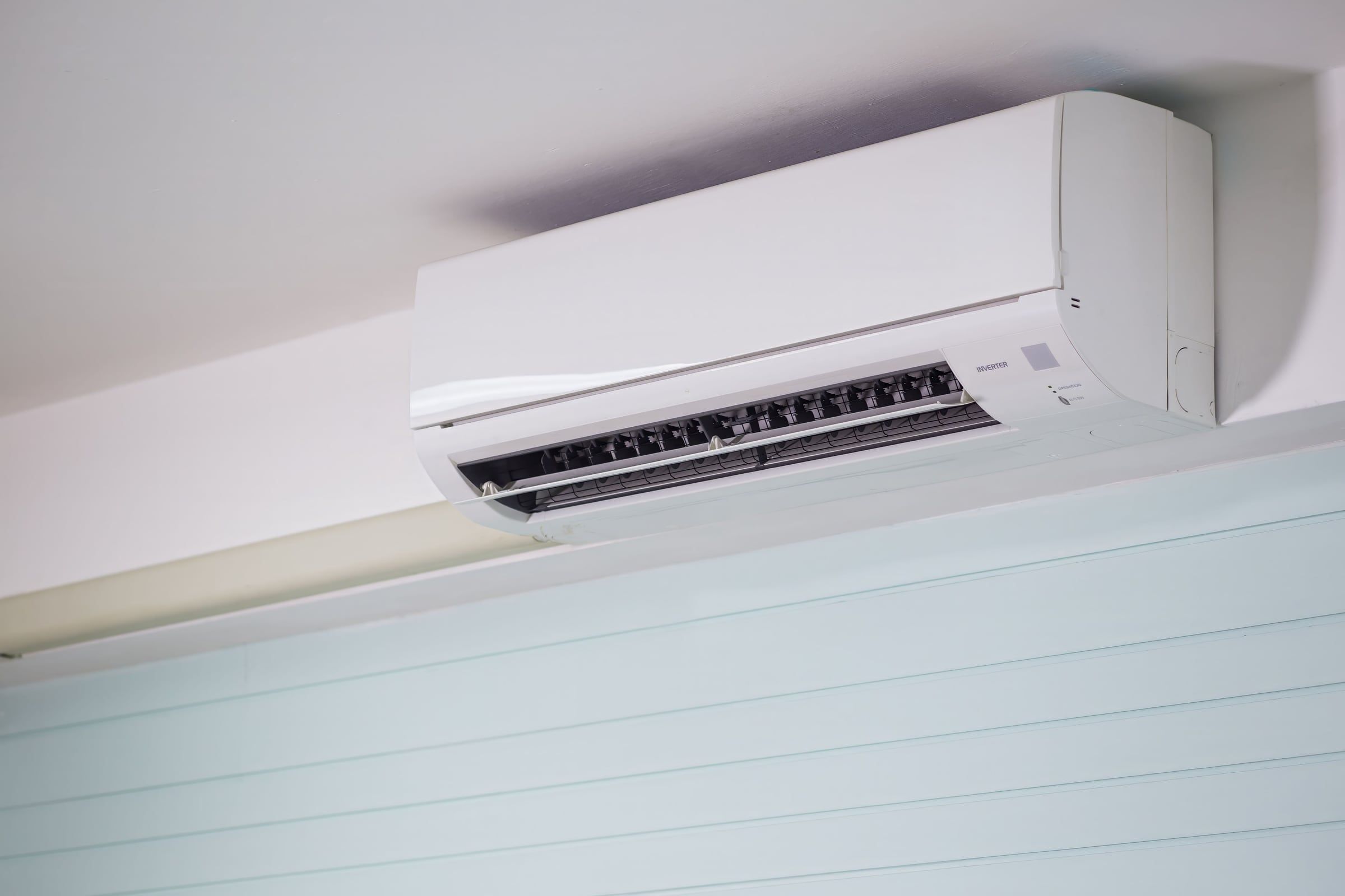 A wall mounted split air conditioning unit with its vanes open.